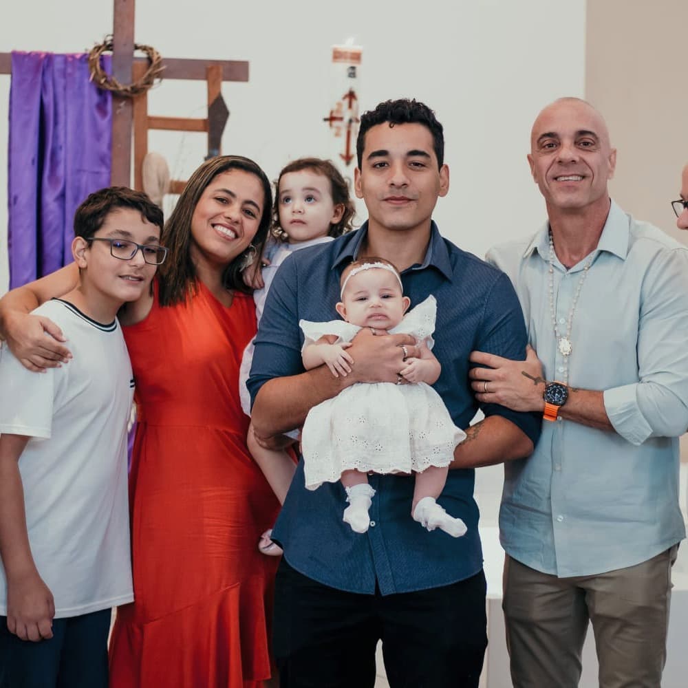 Me holding my cousin while my parents and my brother pose for a family photo